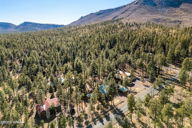 bird's eye view featuring a forest view and a mountain view