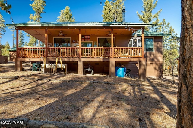 rear view of house with a deck, metal roof, and a ceiling fan