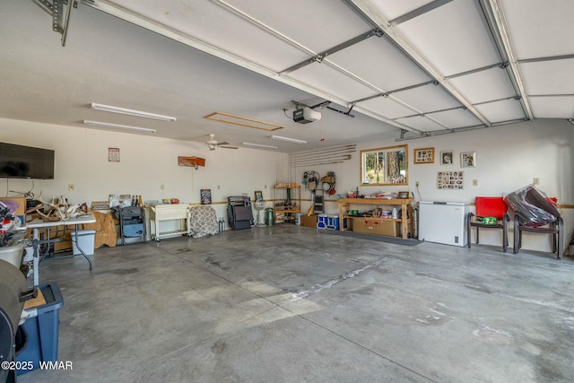 garage featuring a garage door opener, fridge, and a workshop area