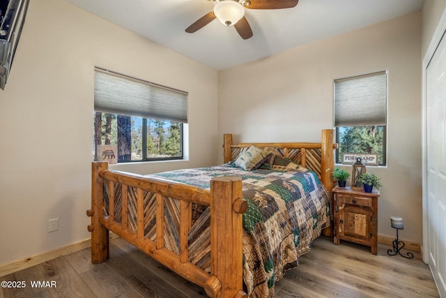 bedroom featuring ceiling fan, wood finished floors, and baseboards