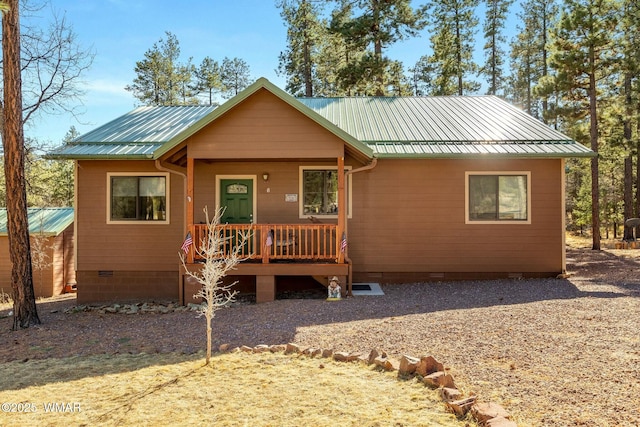 view of front facade featuring crawl space and metal roof