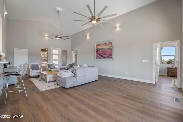 living area with plenty of natural light, ceiling fan, and wood finished floors