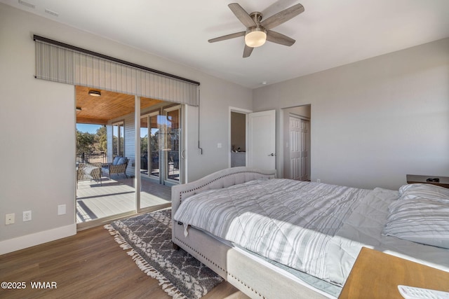 bedroom with access to exterior, baseboards, and wood finished floors