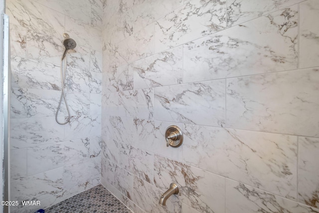 bathroom with a tile shower