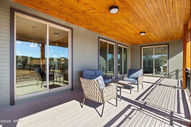 wooden terrace with an outdoor hangout area