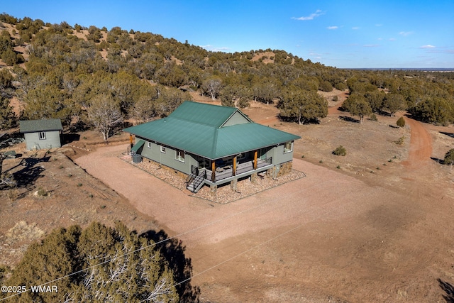 drone / aerial view featuring a wooded view