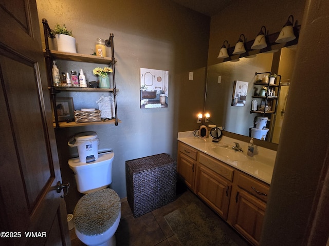 bathroom featuring tile patterned flooring, vanity, and toilet