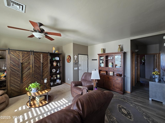 living room featuring visible vents and a ceiling fan