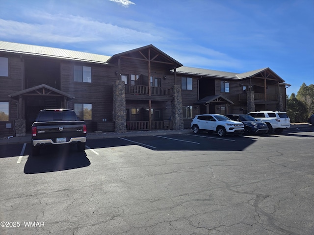 view of building exterior with uncovered parking