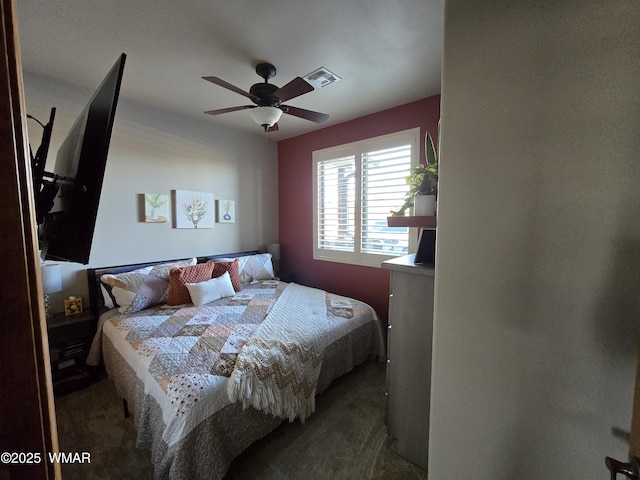 bedroom featuring a ceiling fan, dark colored carpet, and visible vents