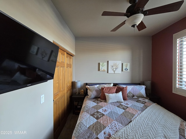 bedroom with a closet, ceiling fan, and dark wood-style flooring