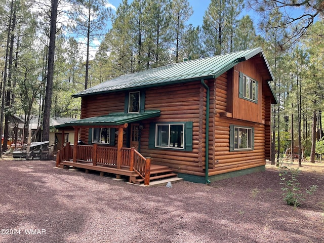6436 Mark Twain Dr, Pinetop, AZ 85935 - view of front of home featuring log exterior, metal roof, a deck, and a standing seam roof
