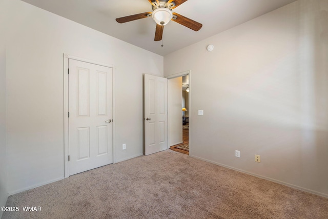 unfurnished bedroom featuring baseboards, carpet flooring, and ceiling fan