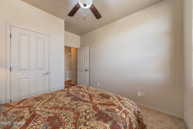 carpeted bedroom with ceiling fan, baseboards, and visible vents