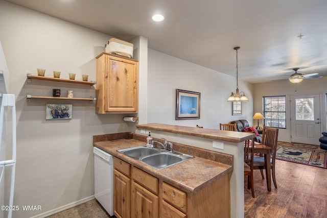 kitchen with a peninsula, a ceiling fan, dishwasher, a sink, and light brown cabinets