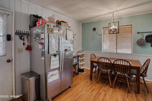 720 S 26th Ave, Show Low, AZ 85901 - dining area featuring light wood-type flooring, a chandelier, a decorative wall, ornamental molding, and wainscoting