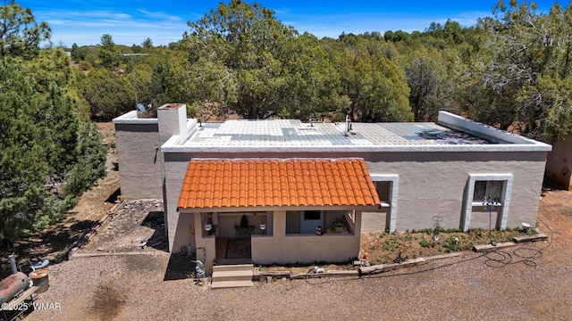1051 Dusty Ln, Show Low, AZ 85901 - view of front of property featuring a tile roof, stucco siding, and a forest view