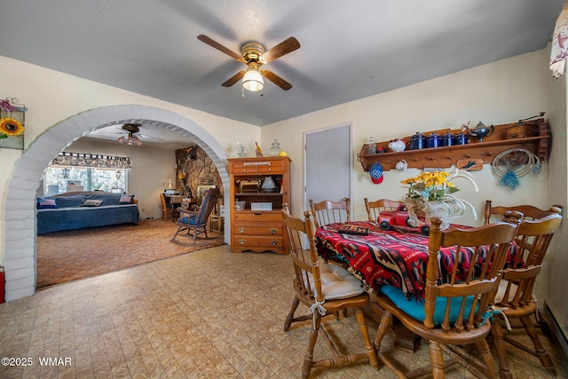 1051 Dusty Ln, Show Low, AZ 85901 - dining space with a ceiling fan, arched walkways, a baseboard radiator, and tile patterned floors