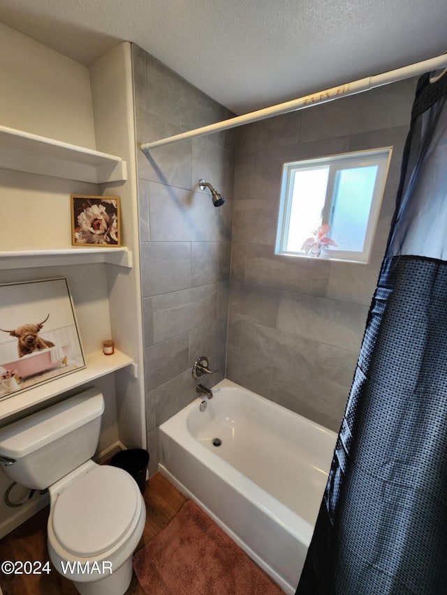 bathroom with shower / tub combo, a textured ceiling, toilet, and wood finished floors