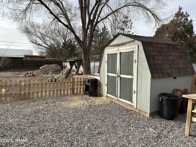 view of shed featuring fence