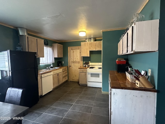 kitchen featuring white appliances, dark tile patterned flooring, dark countertops, ornamental molding, and a sink