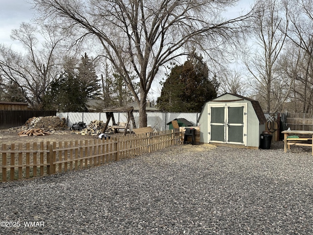 view of yard with an outbuilding, a storage unit, and a fenced backyard