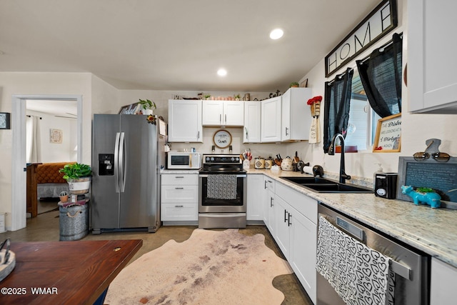 3036 W Plum Blossom Ln, Snowflake, AZ 85937 - kitchen with appliances with stainless steel finishes, white cabinetry, recessed lighting, and light stone counters