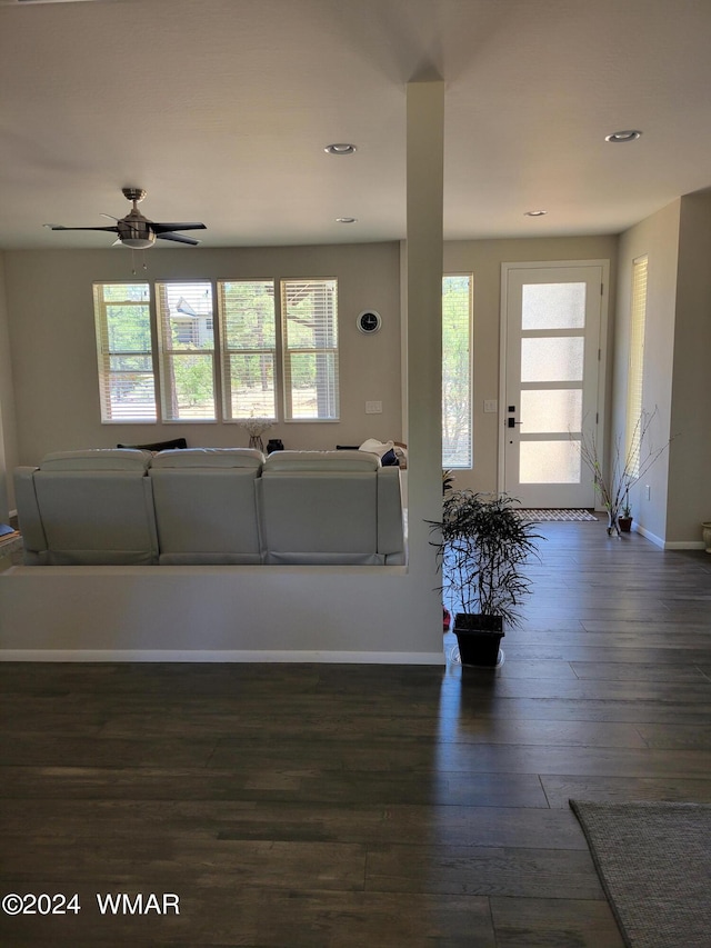 unfurnished living room with dark wood-type flooring, recessed lighting, ceiling fan, and baseboards