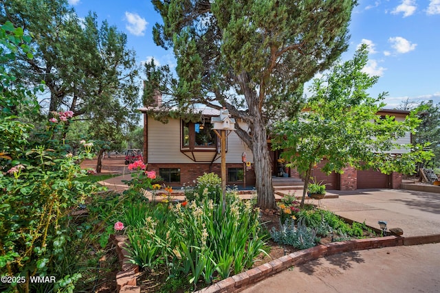6711 Bandido Way, Show Low, AZ 85901 - back of property with driveway, brick siding, and a garage