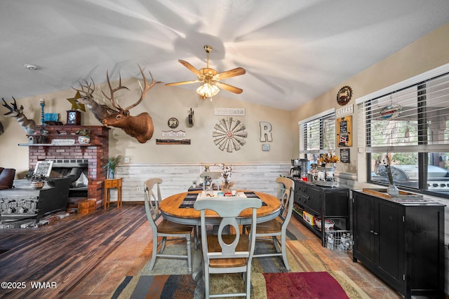 6711 Bandido Way, Show Low, AZ 85901 - dining room featuring vaulted ceiling, a wainscoted wall, ceiling fan, and wood finished floors