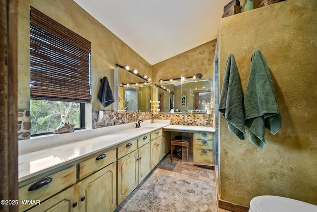 6711 Bandido Way, Show Low, AZ 85901 - bathroom with vaulted ceiling, vanity, a stall shower, stone finish flooring, and a textured wall