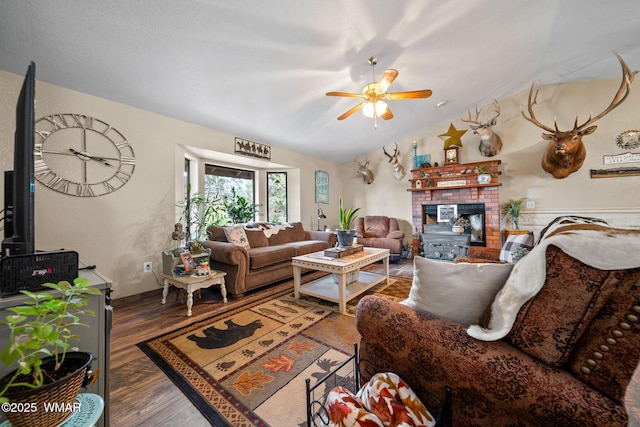 6711 Bandido Way, Show Low, AZ 85901 - living room featuring vaulted ceiling, wood finished floors, ceiling fan, and a fireplace