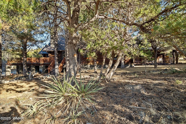 view of yard with stairway and a deck