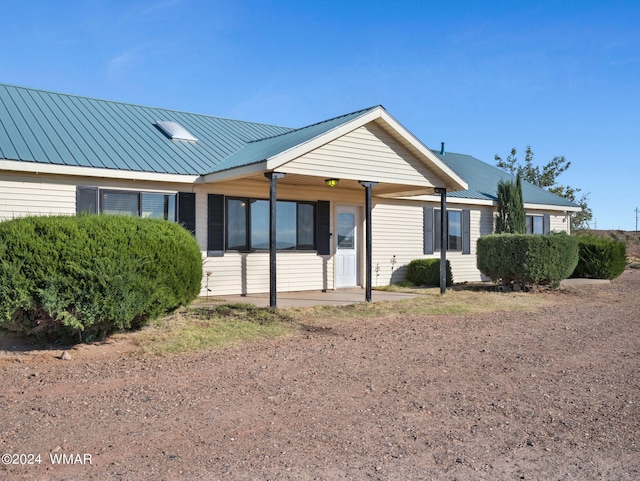 ranch-style home with metal roof