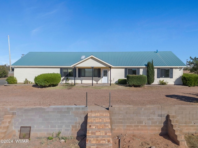 ranch-style house with metal roof