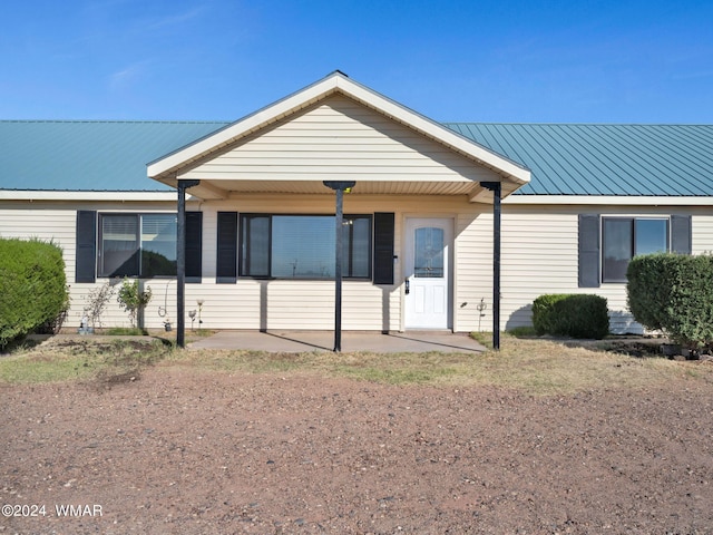 ranch-style house with metal roof