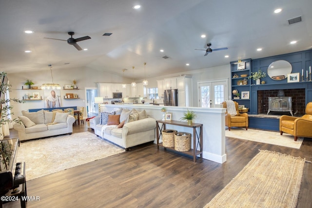 living room featuring french doors, dark wood finished floors, visible vents, vaulted ceiling, and ceiling fan