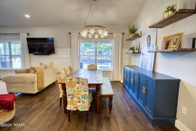 dining room with a wainscoted wall, dark wood finished floors, a notable chandelier, recessed lighting, and a decorative wall