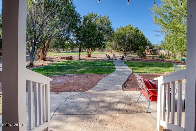 view of community featuring a patio area and a yard