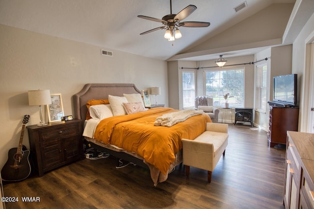 bedroom featuring a wood stove, dark wood-style floors, visible vents, and lofted ceiling