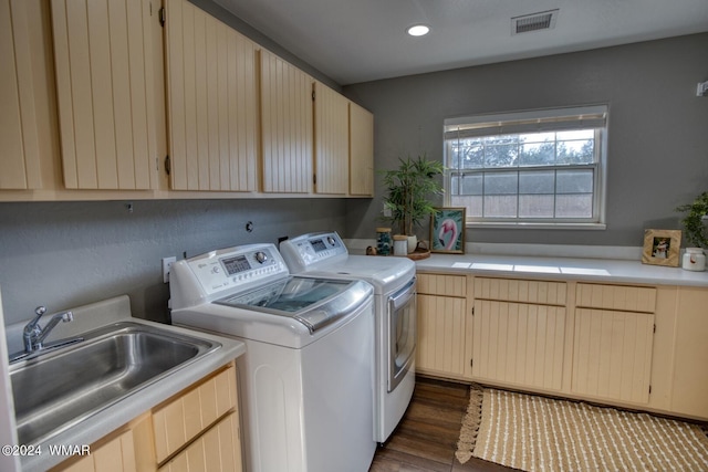 clothes washing area with cabinet space, visible vents, dark wood-type flooring, a sink, and independent washer and dryer