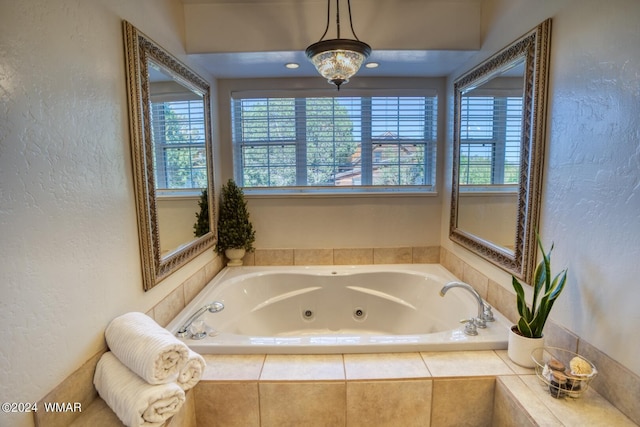 full bath with a jetted tub and a textured wall