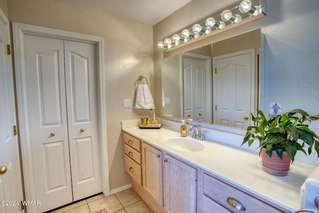 bathroom featuring a closet, vanity, and tile patterned floors