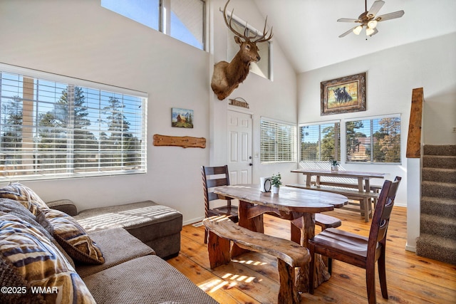 dining area with a healthy amount of sunlight, light wood finished floors, and stairs