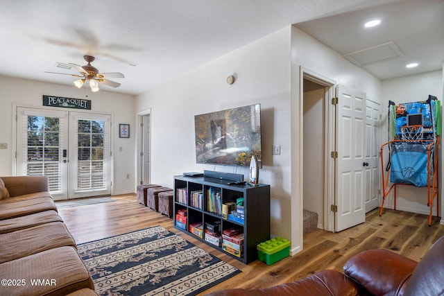 living area with ceiling fan, recessed lighting, wood finished floors, french doors, and attic access