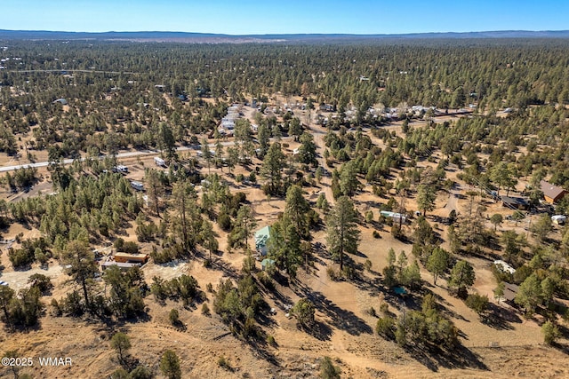 birds eye view of property featuring a view of trees