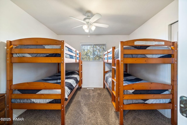 bedroom with dark carpet and a ceiling fan