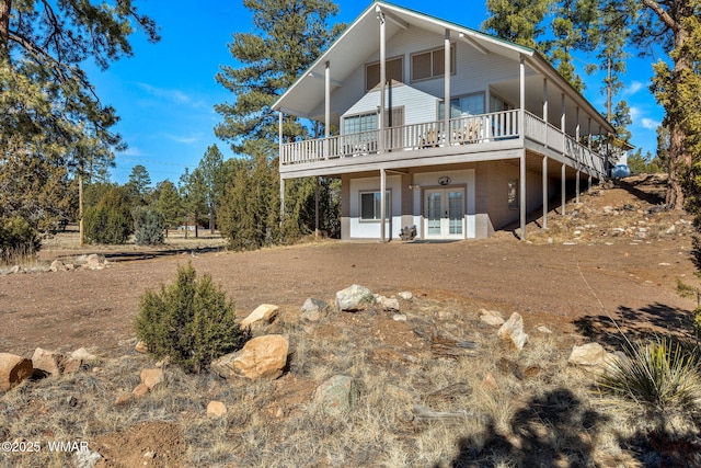 back of house with a deck and french doors