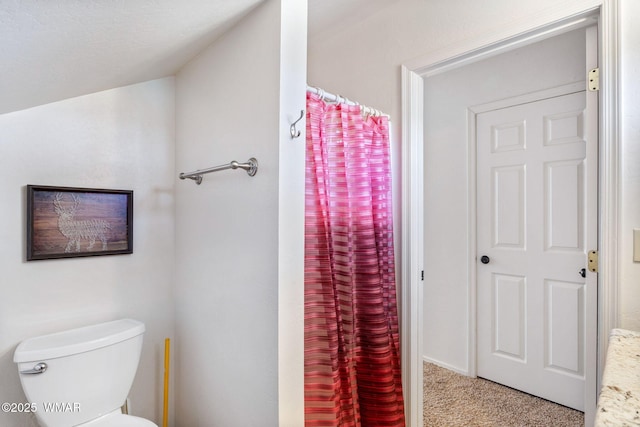 full bathroom with toilet and a shower with shower curtain