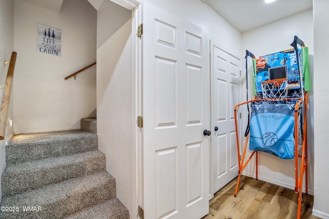 stairway with baseboards and wood finished floors